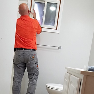 A Kobella technician working on a bathroom renovation