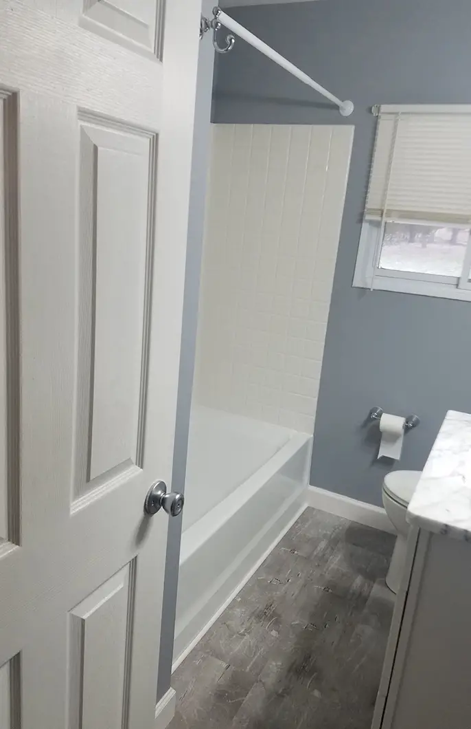 A newly remodeled bathroom with a vanity sink and a new toilet