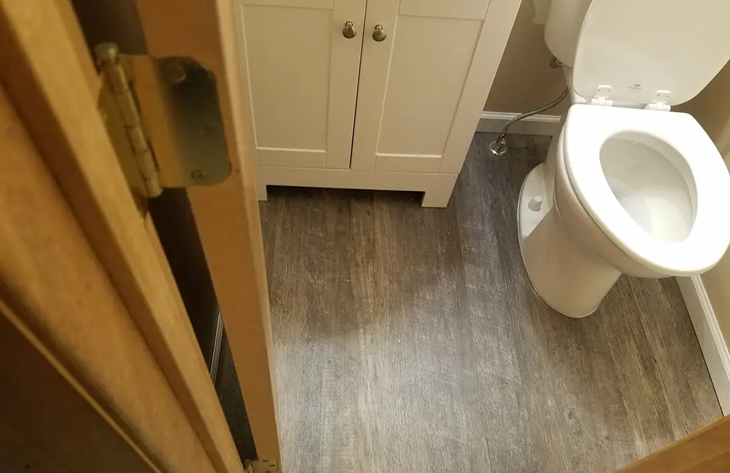A bathroom with a newly installed toilet flooring