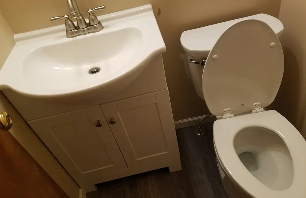 A bathroom with a white toilet and bathtub