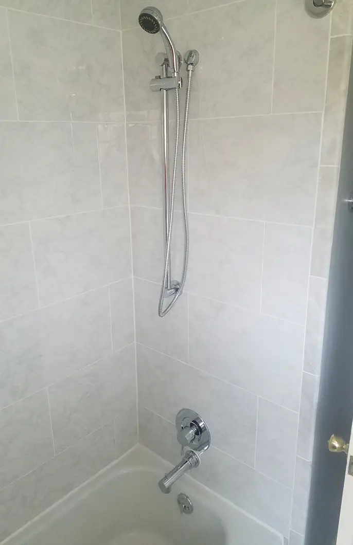 A newly installed showerhead and faucet