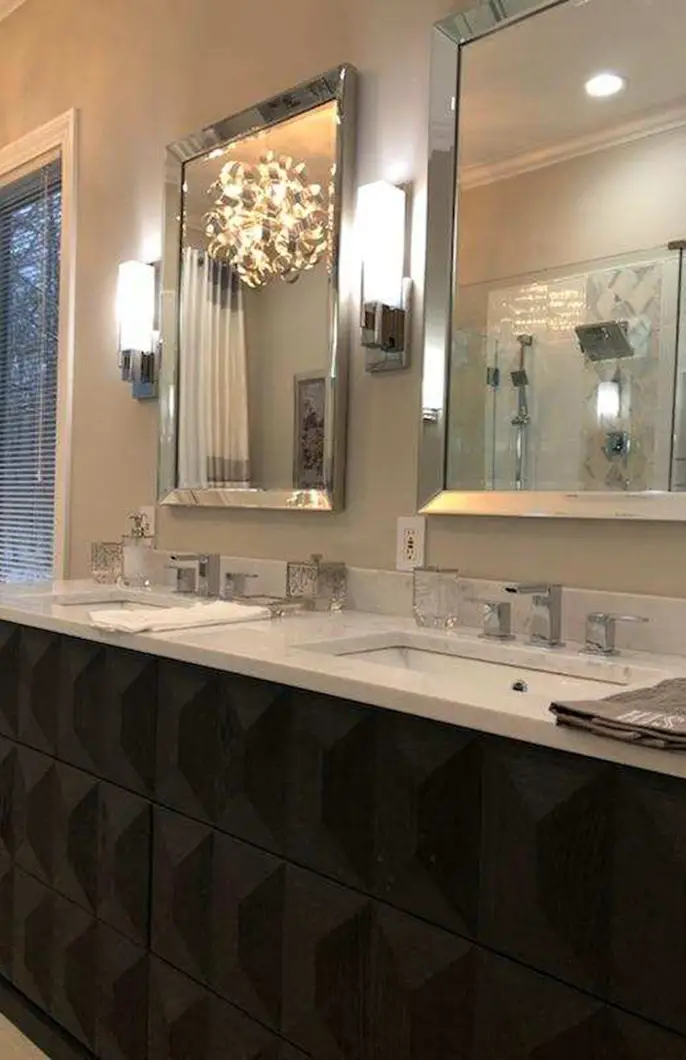 A bathroom counter with a vanity sink and new faucets