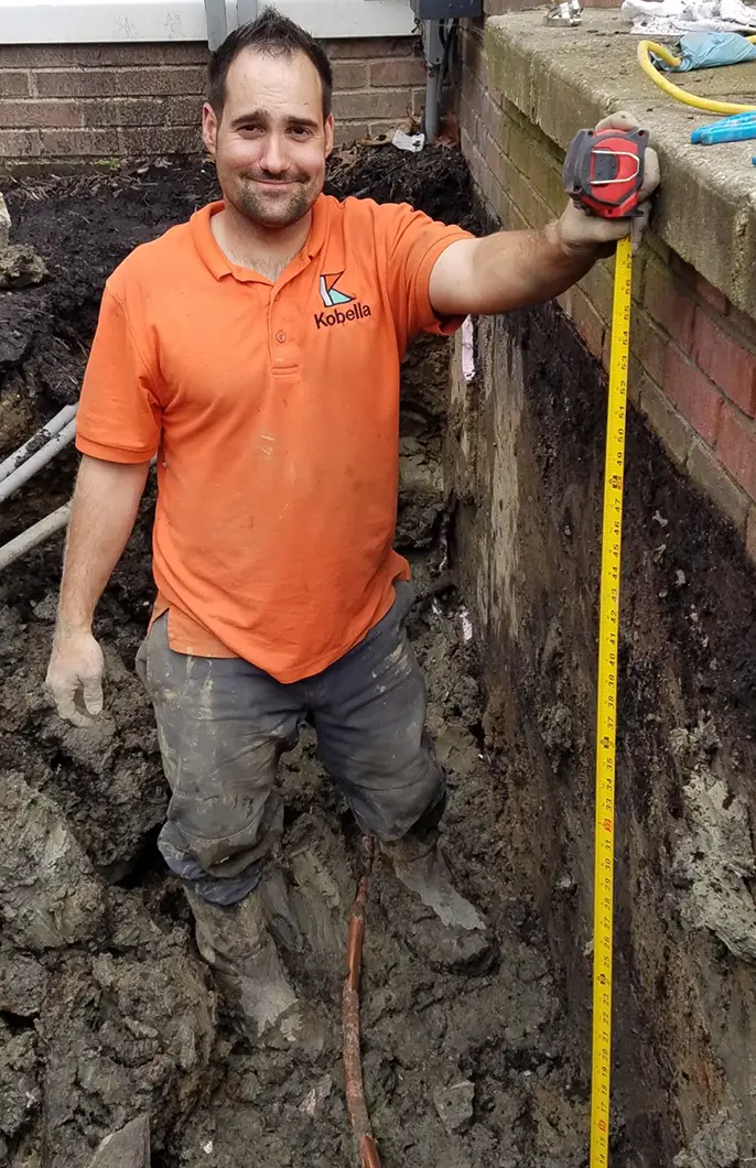 A Kobella plumber performing underground pipe work
