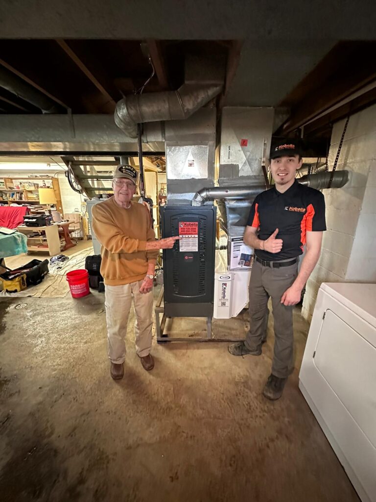 A veteran smiling next to his newly installed furnace