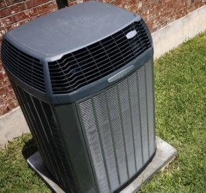 Heat pump unit in backyard of house