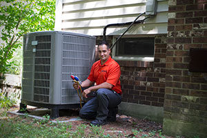 A Kobella technician running diagnostics on an air conditioning unit