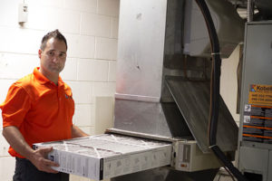 A Kobella technician replacing furnace filters