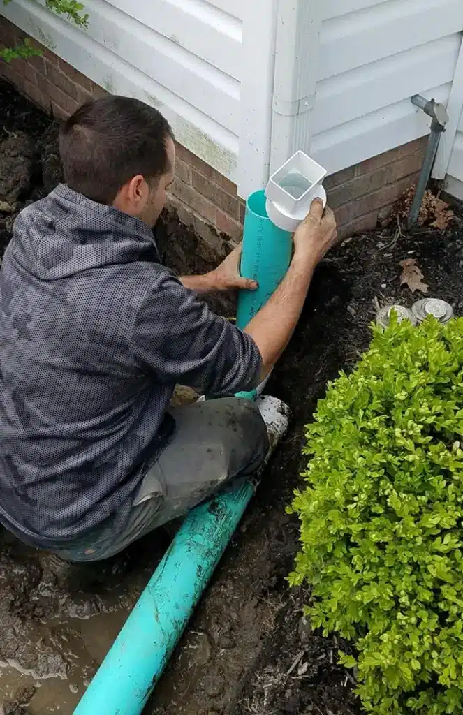 Water lines being installed outside of a customer's home by a technician
